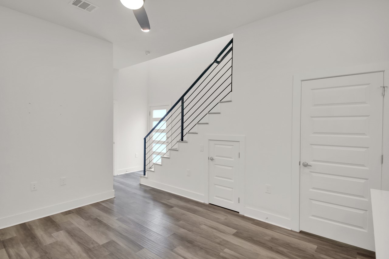 6325 Ponca Street, Unit B Austin, TX 78741 - Photo 5 of 29 Stairway with wood finished floors and a ceiling fan