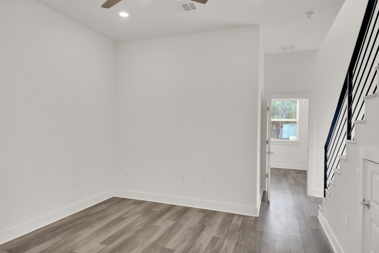 6325 Ponca Street, Unit B Austin, TX 78741 - Photo 6 of 29 Empty room featuring a ceiling fan, wood finished floors, and recessed lighting