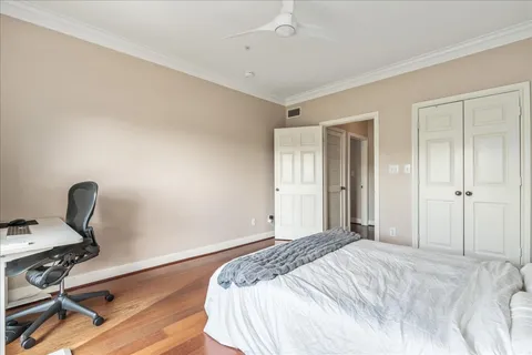 a bedroom with a bed and a desk
