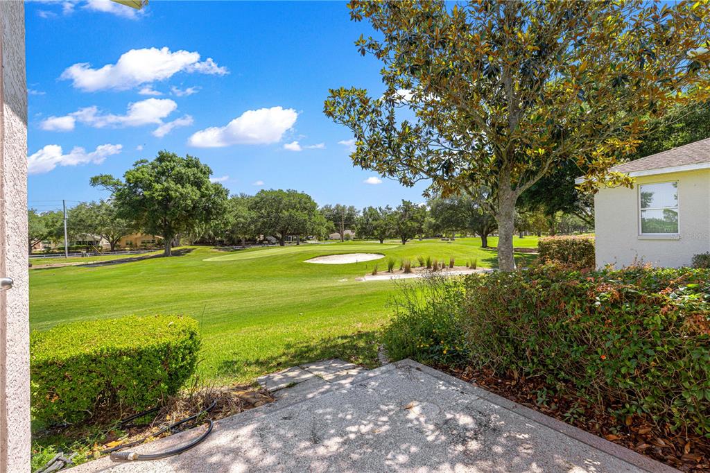 9317 Southwest 94th Loop Ocala, FL 34481 - Photo 30 of 40 a view of a golf course with a big yard