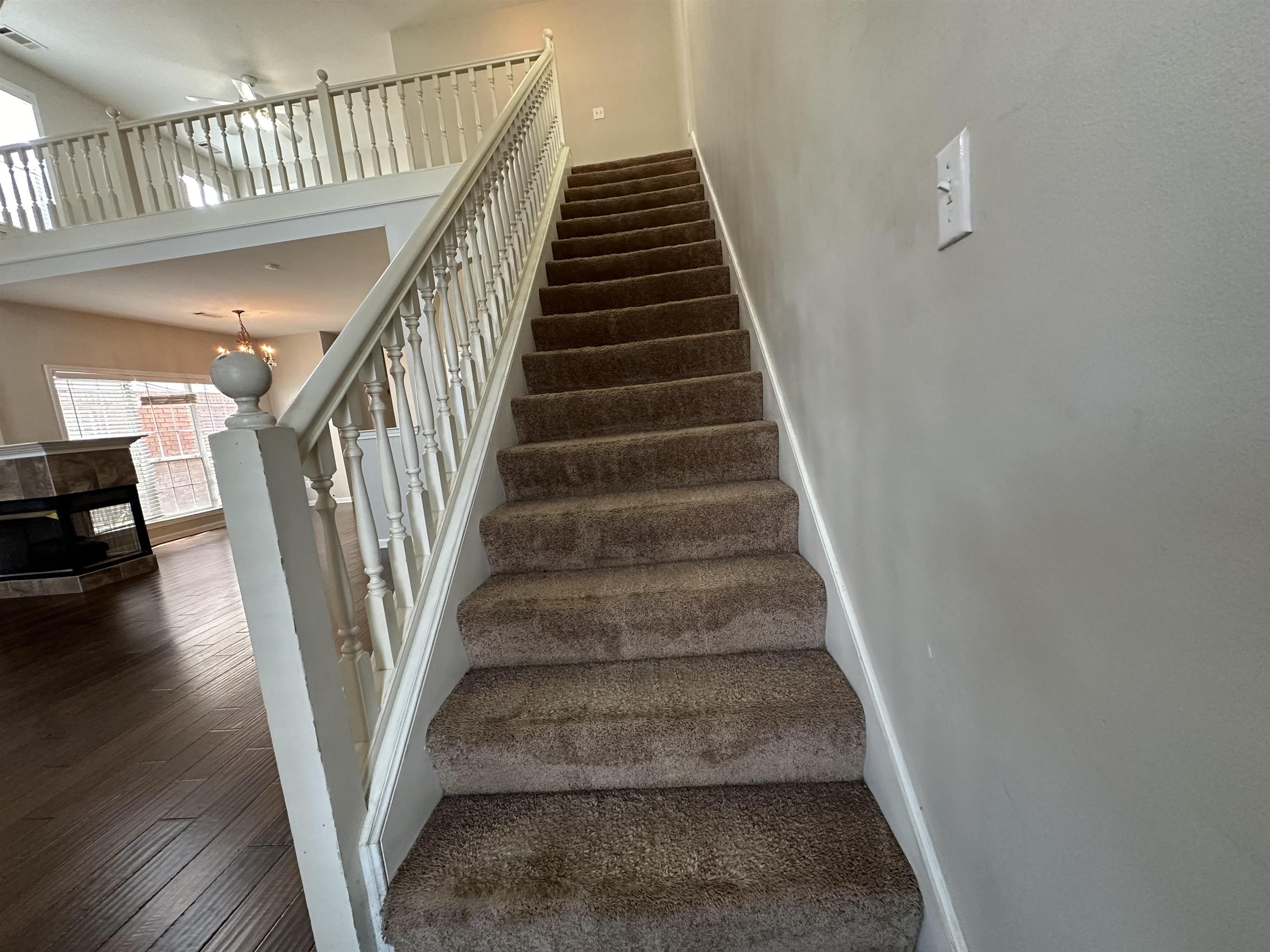 4567 Park Ridge Parkway Collierville, TN 38017 - Photo 16 of 23 Stairway featuring a high ceiling and wood-type flooring