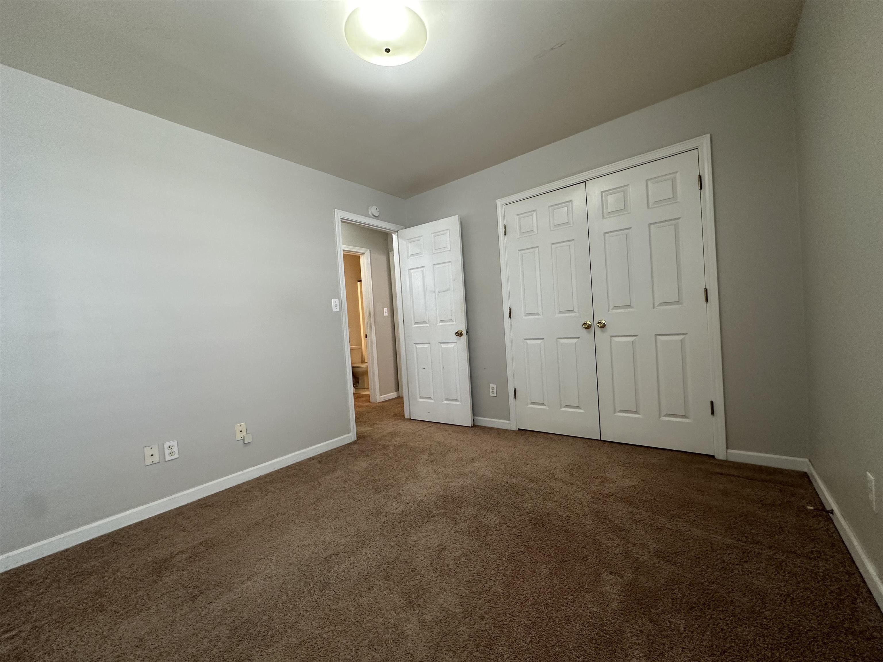 4567 Park Ridge Parkway Collierville, TN 38017 - Photo 19 of 23 Unfurnished bedroom featuring dark colored carpet and a closet