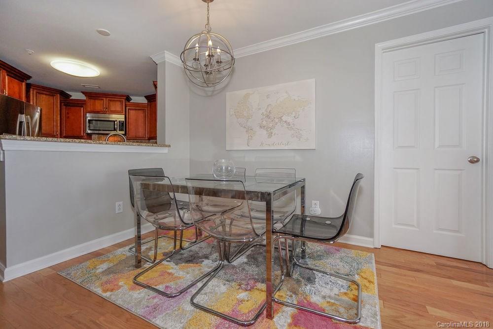 1332 Torrence Circle, Unit 1332 Davidson, NC 28036 - Photo 11 of 24 a view of a dining room with furniture and wooden floor