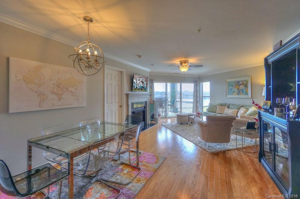 1332 Torrence Circle, Unit 1332 Davidson, NC 28036 - Photo 12 of 24 a living room with dining table a window and a dining table with wooden floor