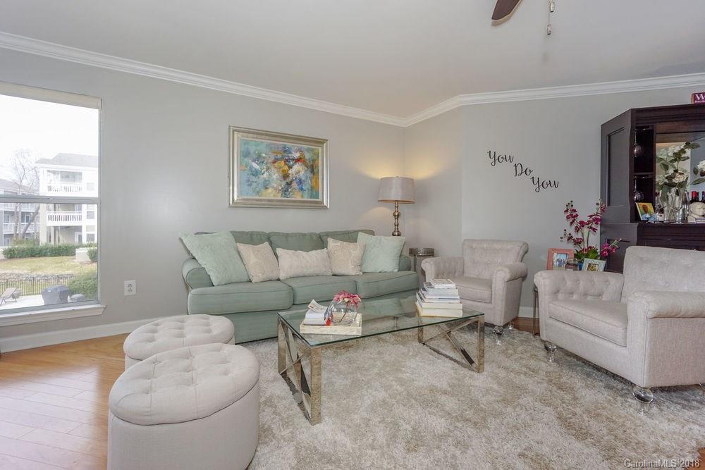 1332 Torrence Circle, Unit 1332 Davidson, NC 28036 - Photo 13 of 24 a living room with furniture and a large window