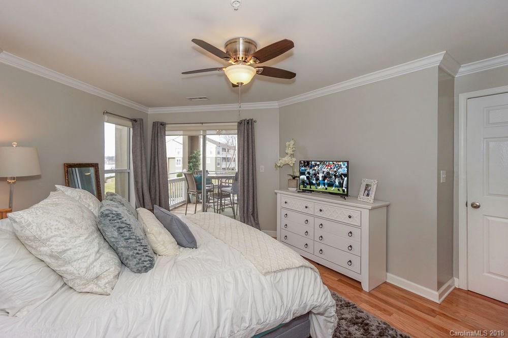 1332 Torrence Circle, Unit 1332 Davidson, NC 28036 - Photo 15 of 24 a bedroom with a large bed and a window