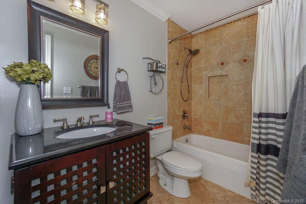 1332 Torrence Circle, Unit 1332 Davidson, NC 28036 - Photo 19 of 24 a bathroom with a sink a toilet and shower