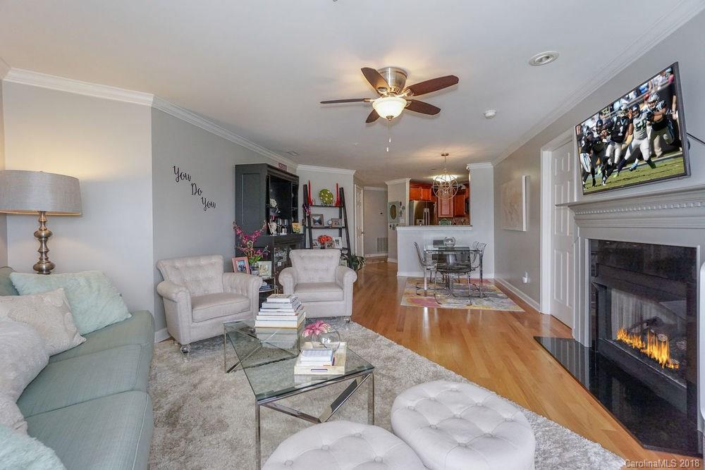 1332 Torrence Circle, Unit 1332 Davidson, NC 28036 - Photo 8 of 24 a living room with fireplace furniture and a wooden floor