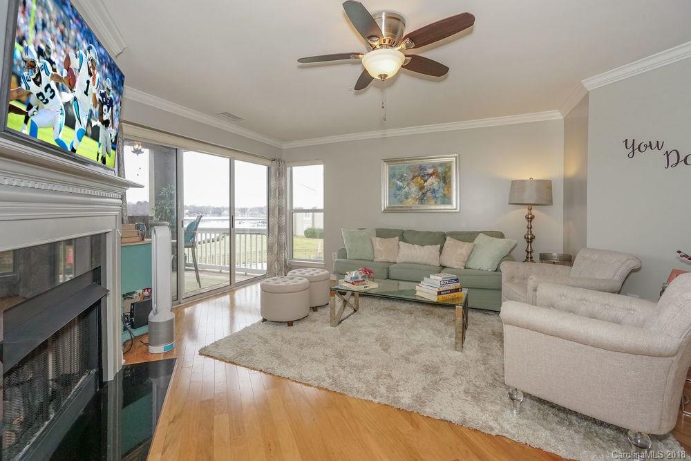 1332 Torrence Circle, Unit 1332 Davidson, NC 28036 - Photo 9 of 24 a living room with furniture and a fireplace