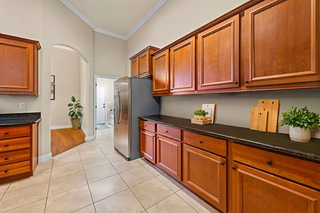 a kitchen with stainless steel appliances granite countertop a refrigerator and a sink