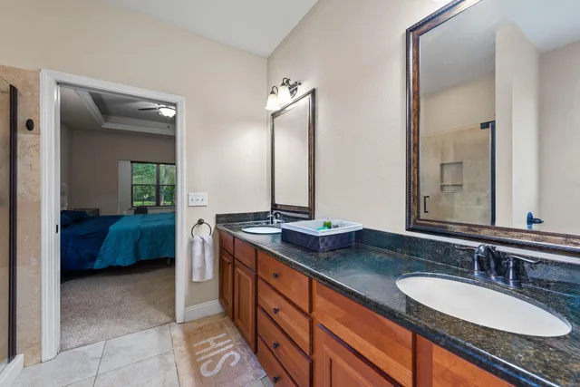 a spacious bathroom with a granite countertop sink and a mirror