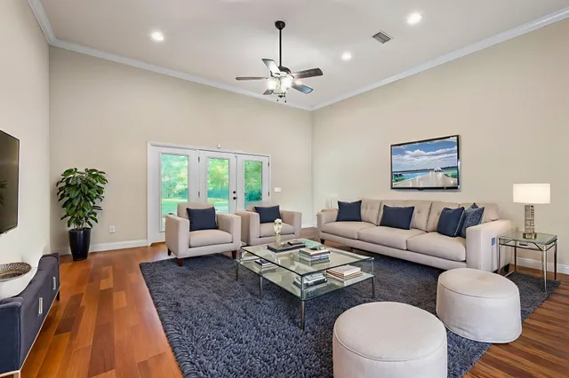a living room with furniture a chandelier and a table