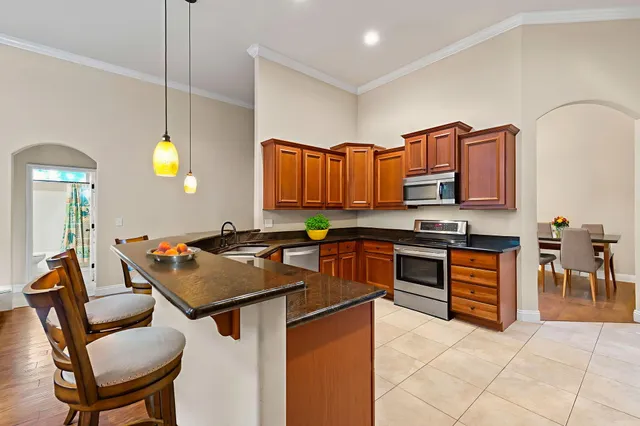 a kitchen that has a table and chairs in it