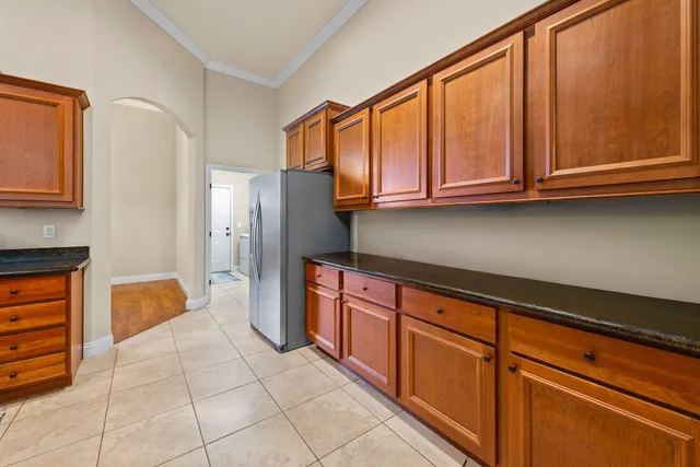 a kitchen with stainless steel appliances granite countertop a refrigerator and cabinets