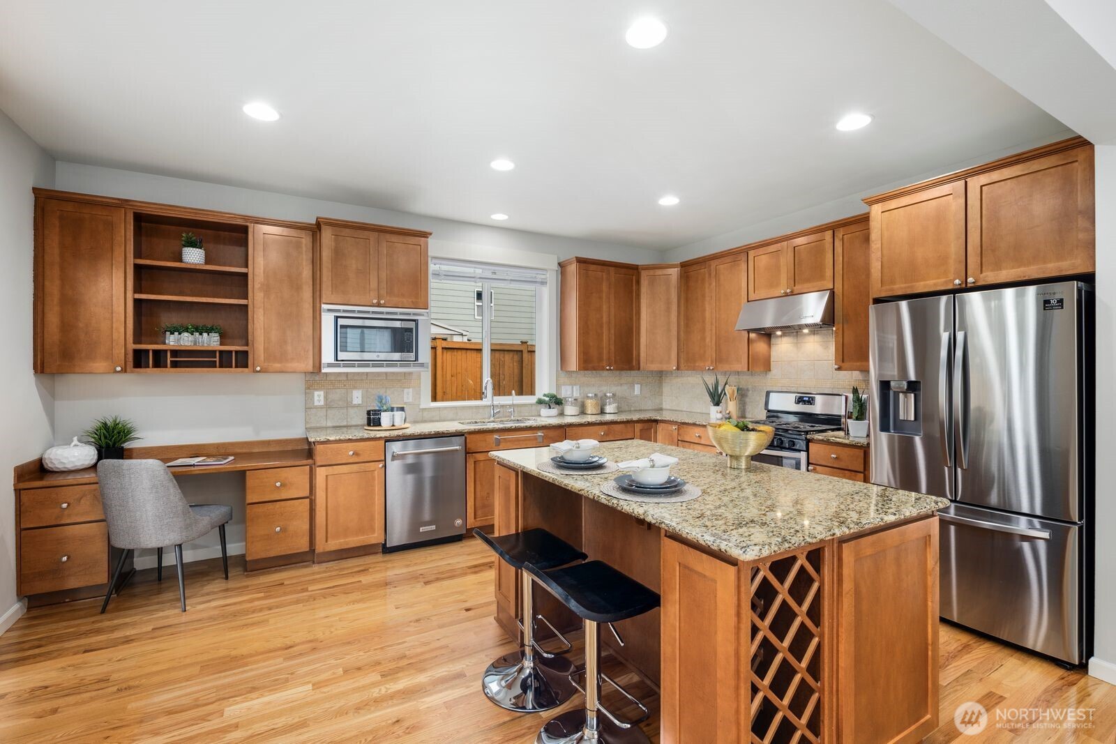 5620 Northeast 6th Place Renton, WA 98059 - Photo 13 of 37 a kitchen with stainless steel appliances granite countertop sink refrigerator and microwave