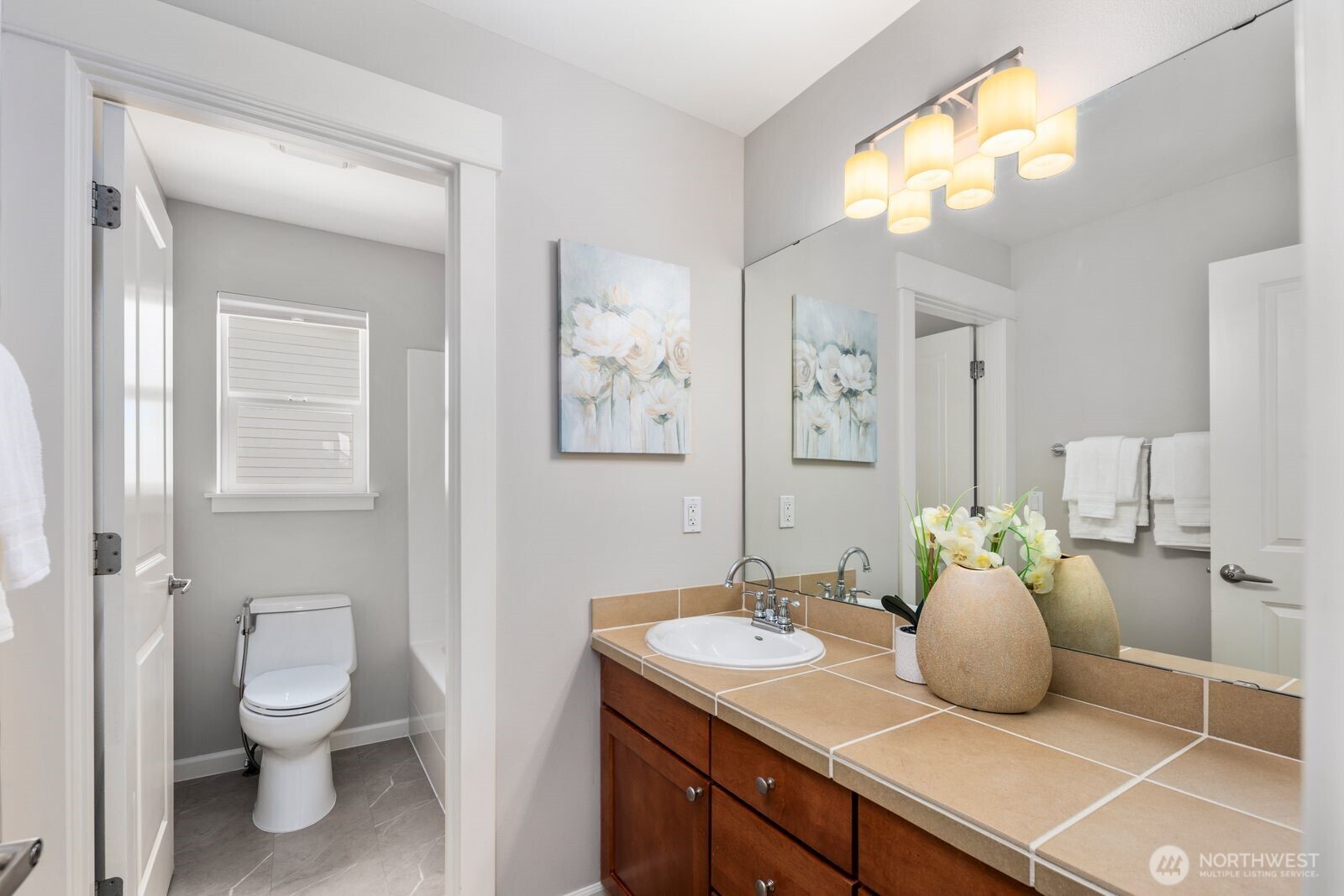 5620 Northeast 6th Place Renton, WA 98059 - Photo 25 of 37 a bathroom with a toilet sink and mirror