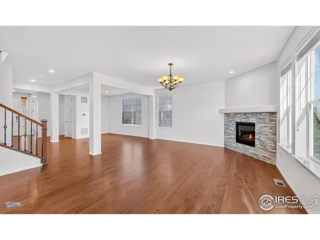 a open hall with a fireplace and wooden floor