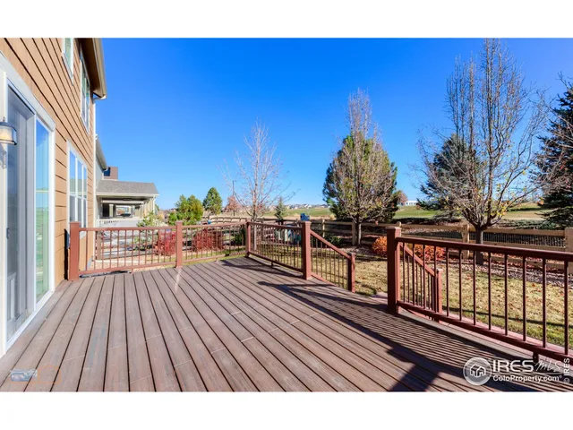 a view of a balcony with wooden floor and outdoor seating