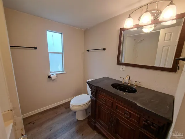 a bathroom with a sink a toilet and mirror