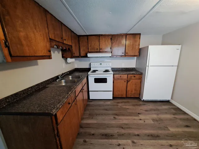 a kitchen with a stove top oven sink and cabinets