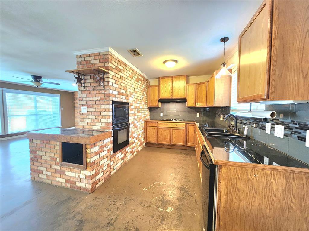 204 Ranch House Road Willow Park, TX 76087 - Photo 9 of 22 a kitchen with stainless steel appliances granite countertop a stove a sink and a microwave