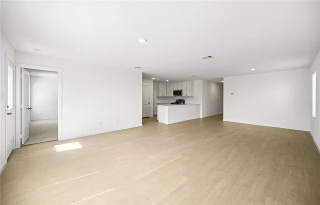 a view of a kitchen with a sink and a refrigerator