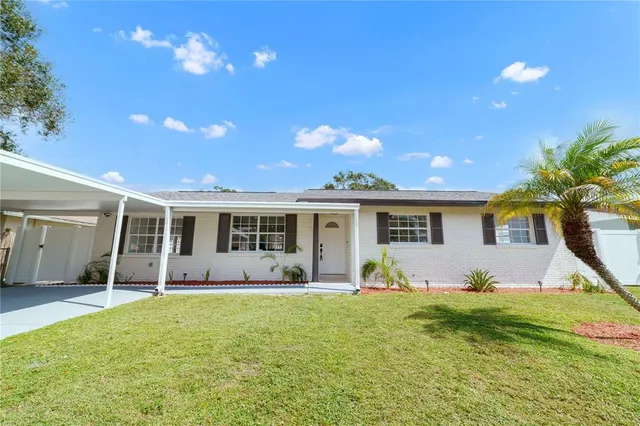 a front view of house with yard outdoor seating and green space