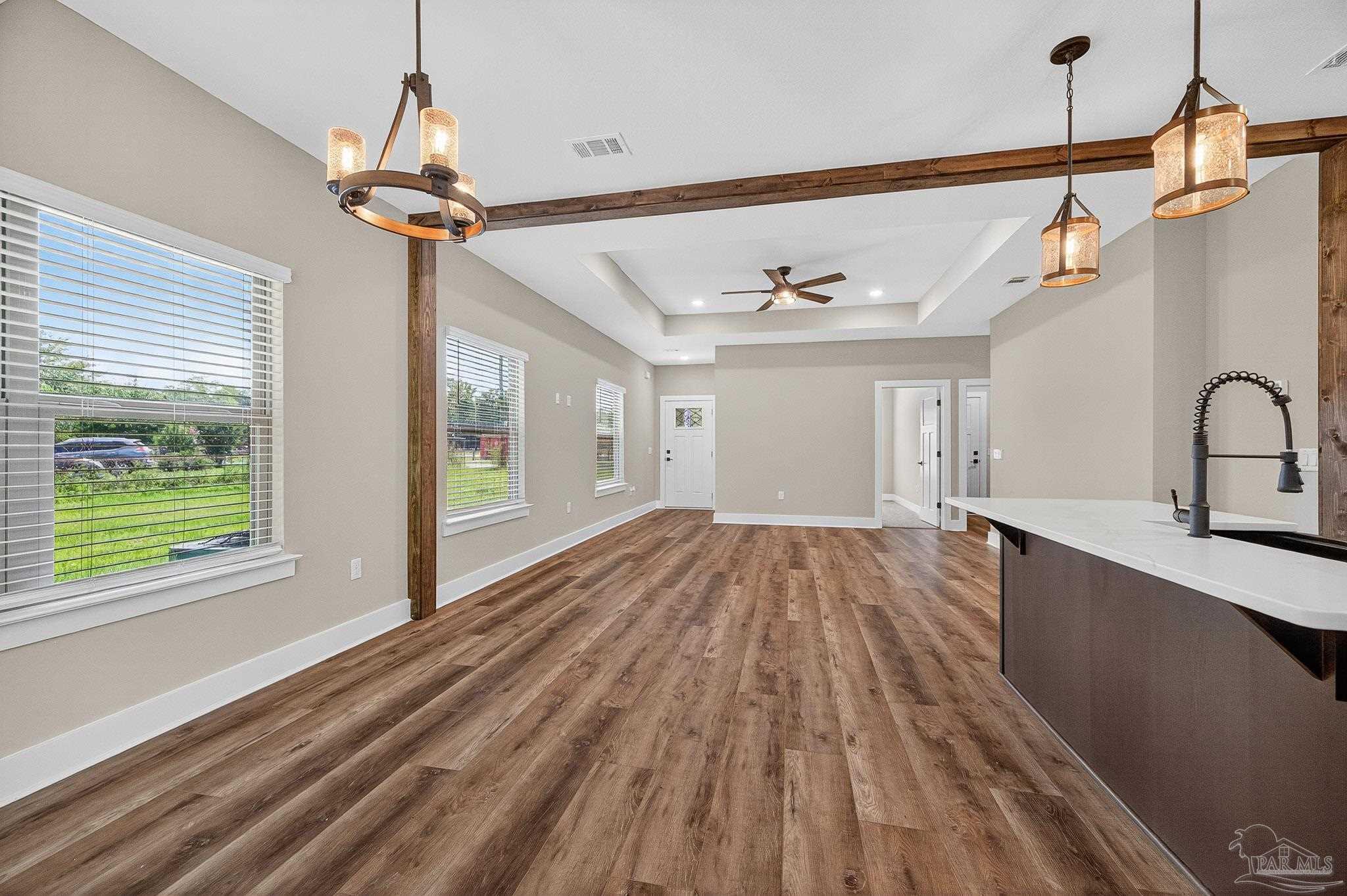 205 Webb Street Cantonment, FL 32533 - Photo 12 of 49 a view of a room with a sink and wooden floor