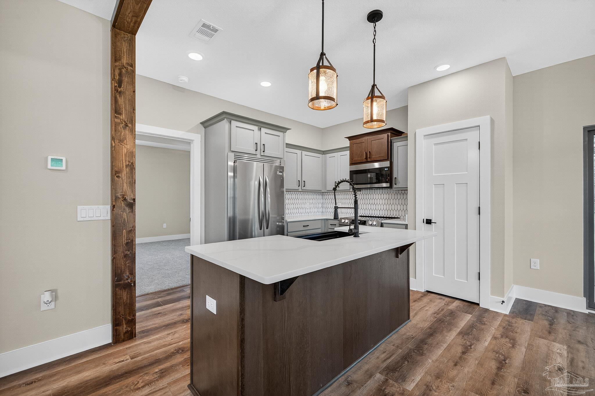 205 Webb Street Cantonment, FL 32533 - Photo 14 of 49 a kitchen with stainless steel appliances granite countertop a sink a stove and a refrigerator