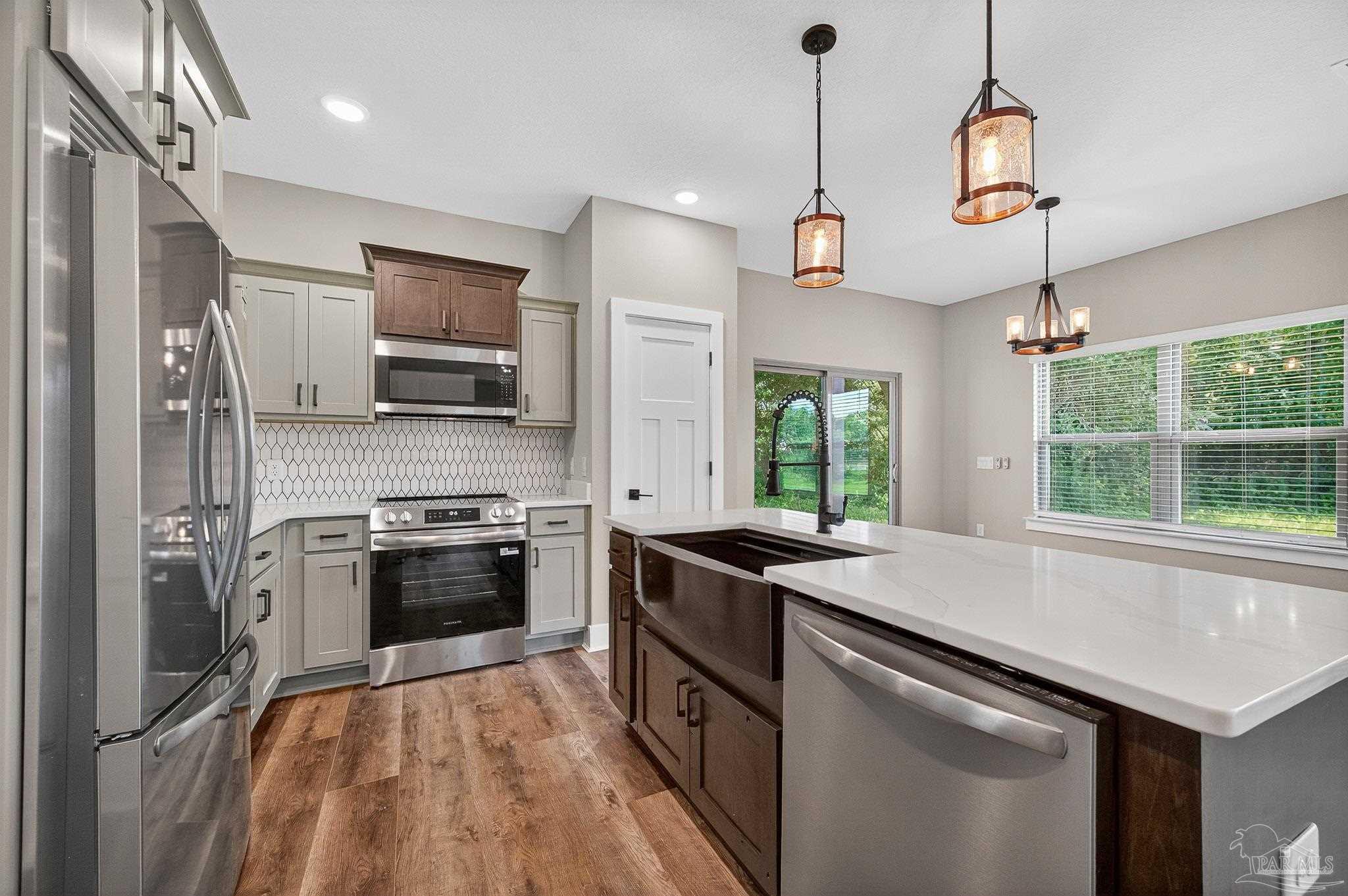 205 Webb Street Cantonment, FL 32533 - Photo 15 of 49 a kitchen with a stove a sink and a refrigerator