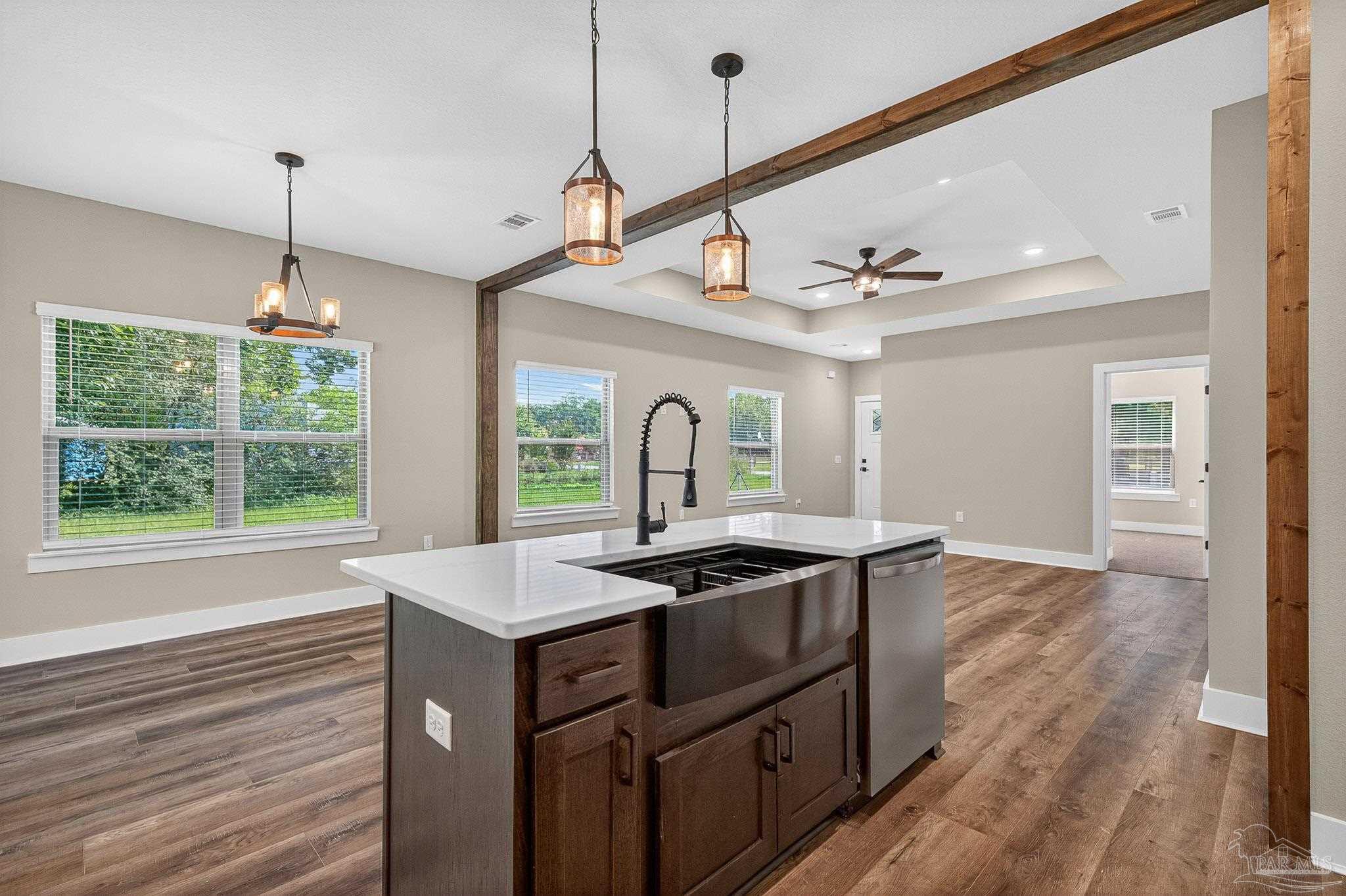 205 Webb Street Cantonment, FL 32533 - Photo 17 of 49 a kitchen with a sink stove and wooden floor