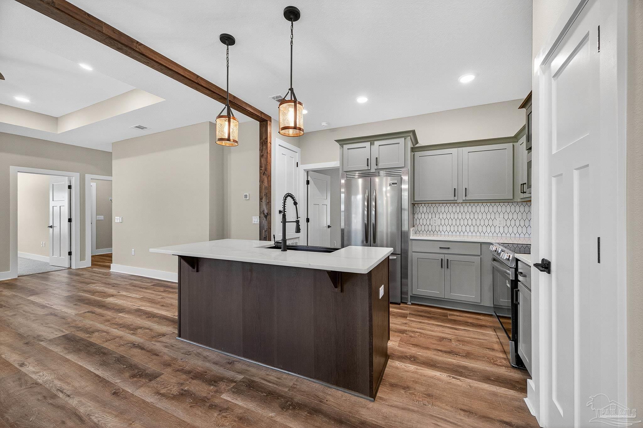 205 Webb Street Cantonment, FL 32533 - Photo 18 of 49 a view of a kitchen with a sink stainless steel appliances and cabinets