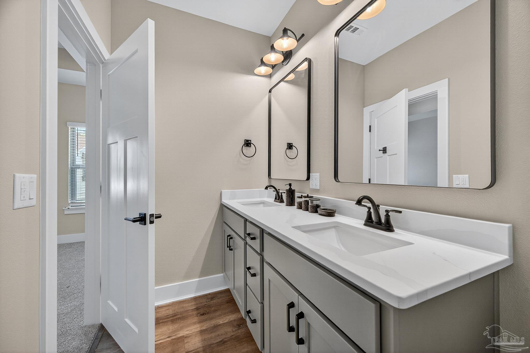 205 Webb Street Cantonment, FL 32533 - Photo 25 of 49 a bathroom with a sink and a mirror