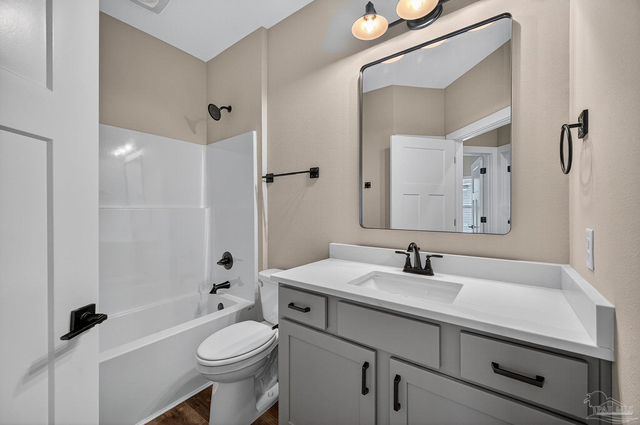 205 Webb Street Cantonment, FL 32533 - Photo 35 of 49 a bathroom with a sink a toilet and shower a mirror