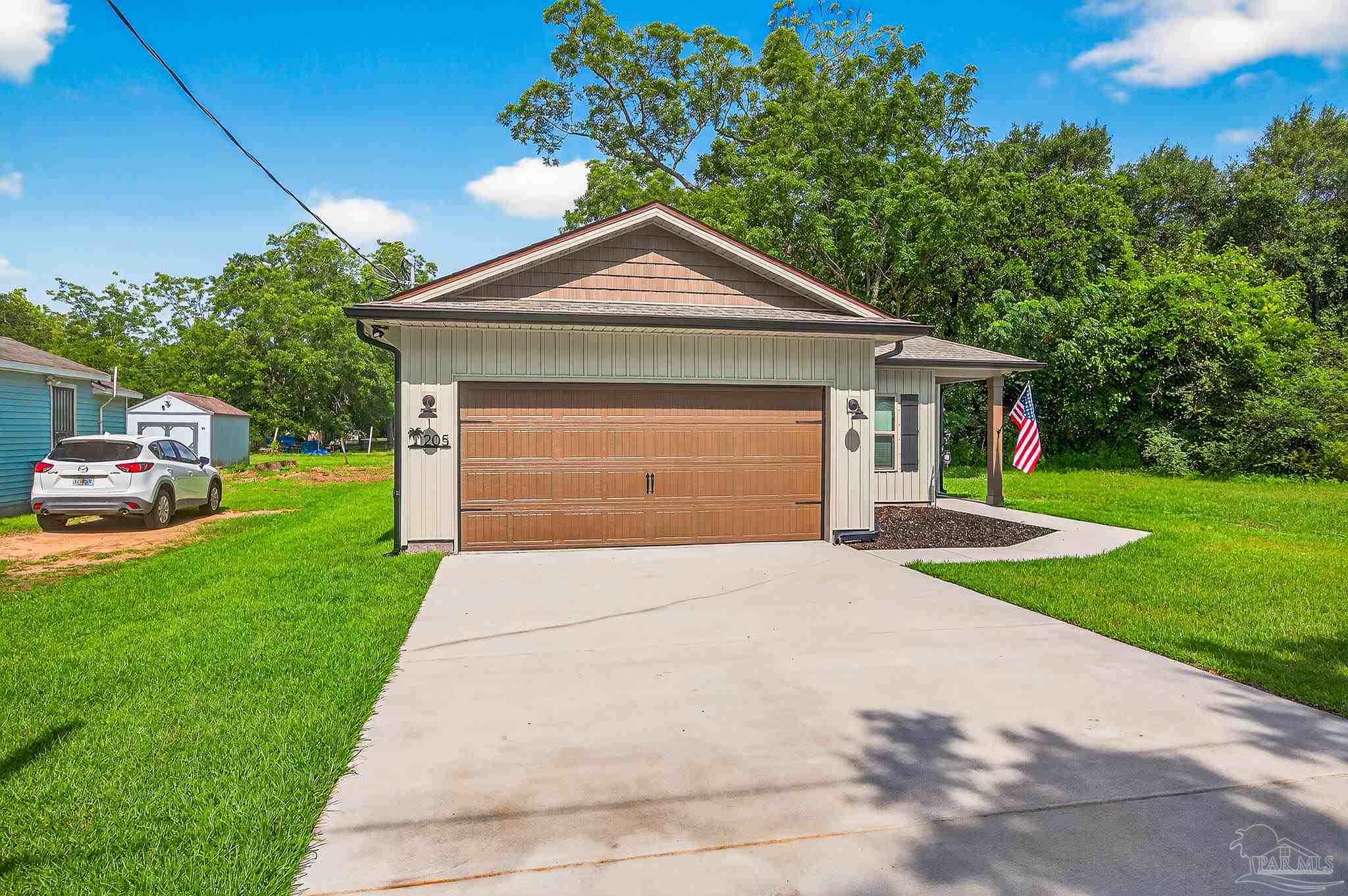 205 Webb Street Cantonment, FL 32533 - Photo 4 of 49 a front view of house with yard and green space