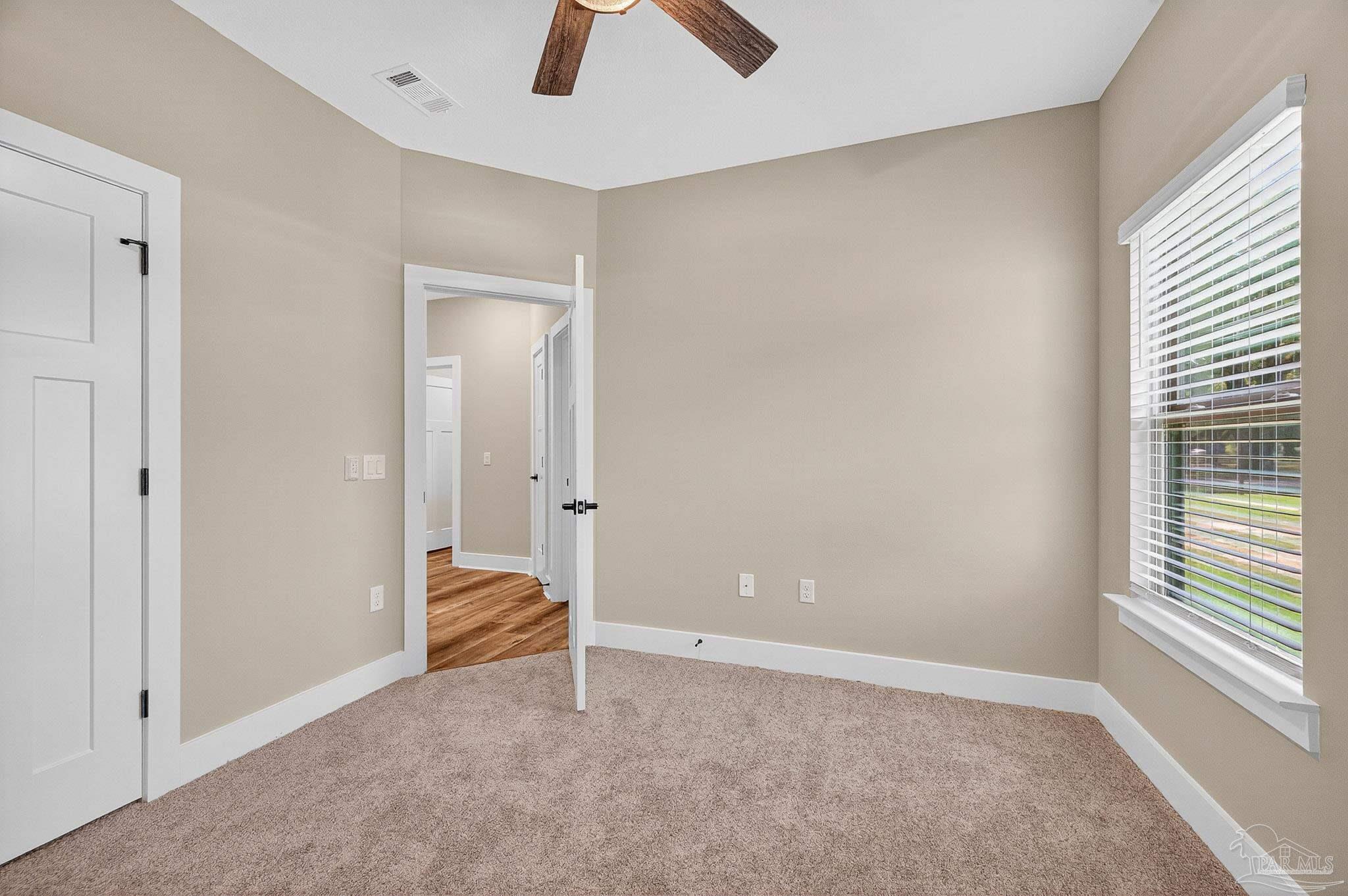 205 Webb Street Cantonment, FL 32533 - Photo 41 of 49 an empty room with closet and a chandelier fan