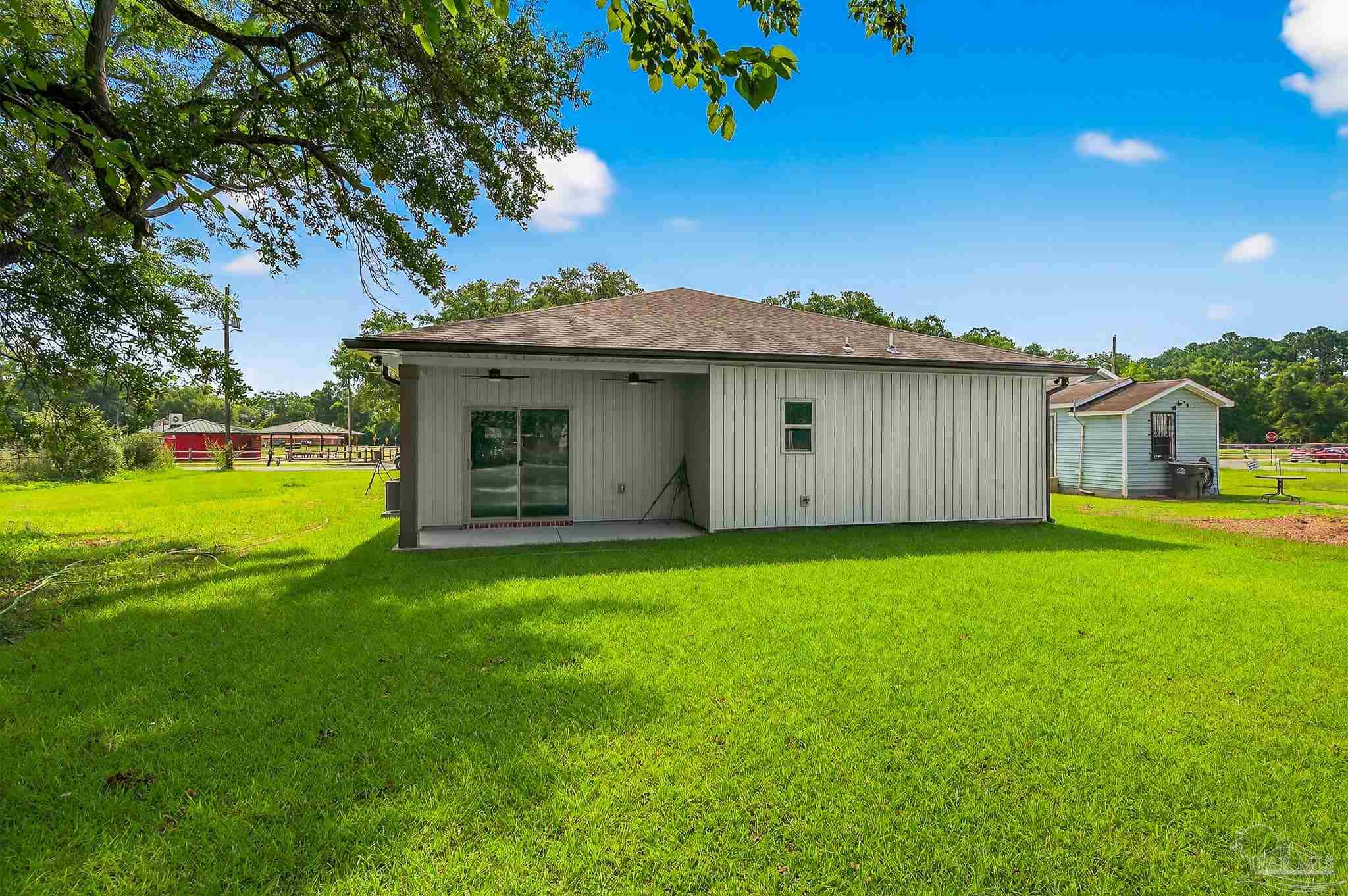 205 Webb Street Cantonment, FL 32533 - Photo 44 of 49 a view of a house with a garden