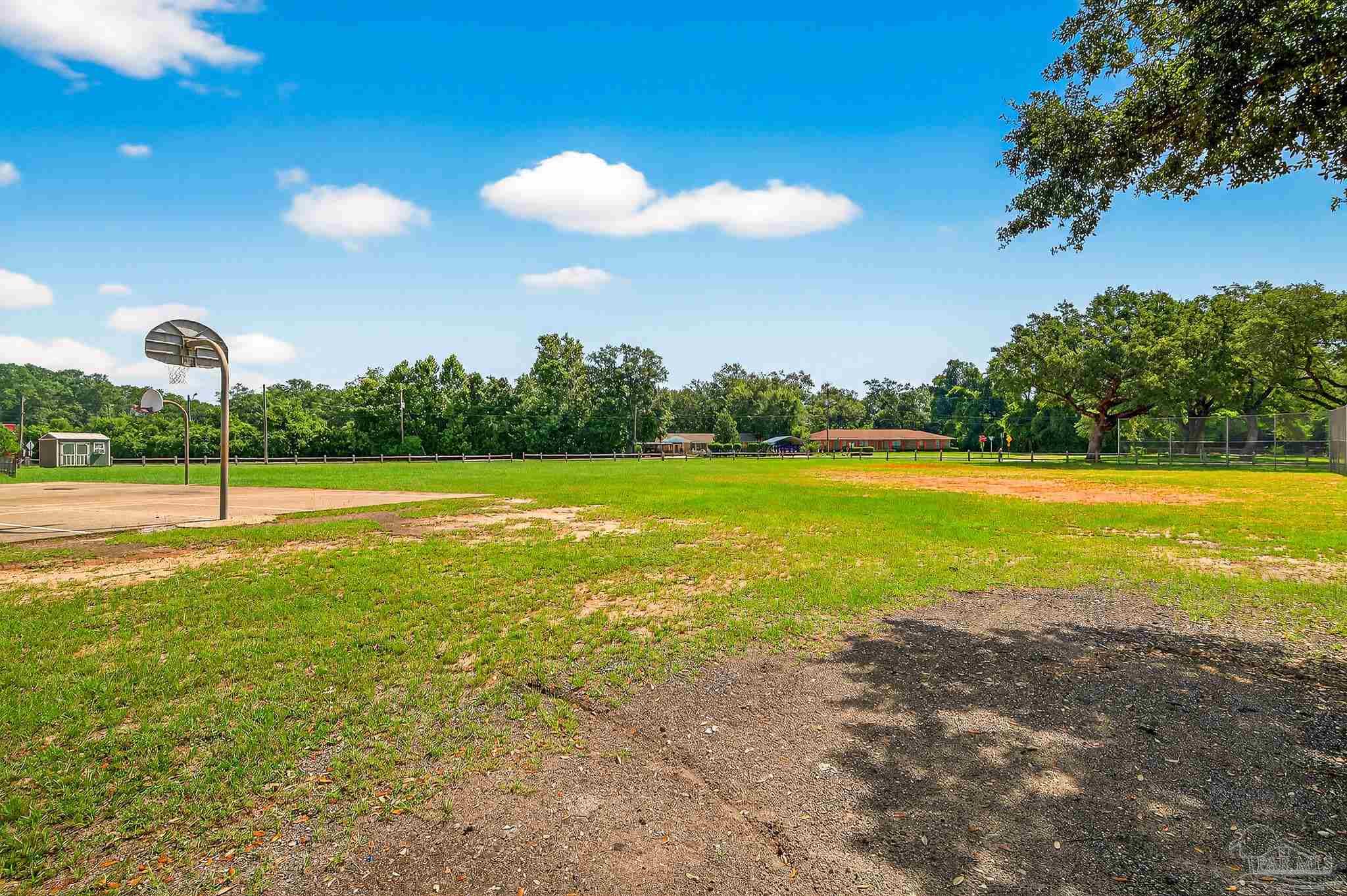 205 Webb Street Cantonment, FL 32533 - Photo 49 of 49 a view of a swimming pool with an outdoor space and seating area
