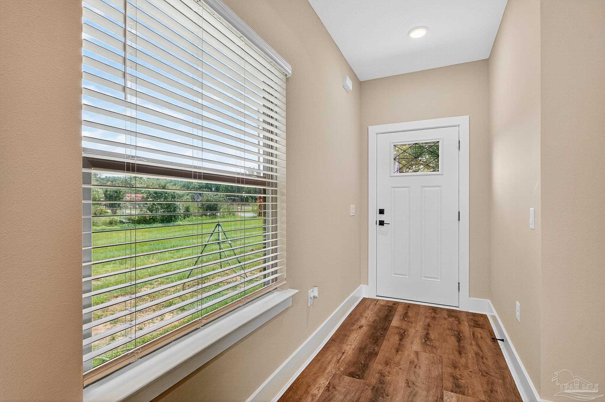 205 Webb Street Cantonment, FL 32533 - Photo 5 of 49 a view of a room that has a large window