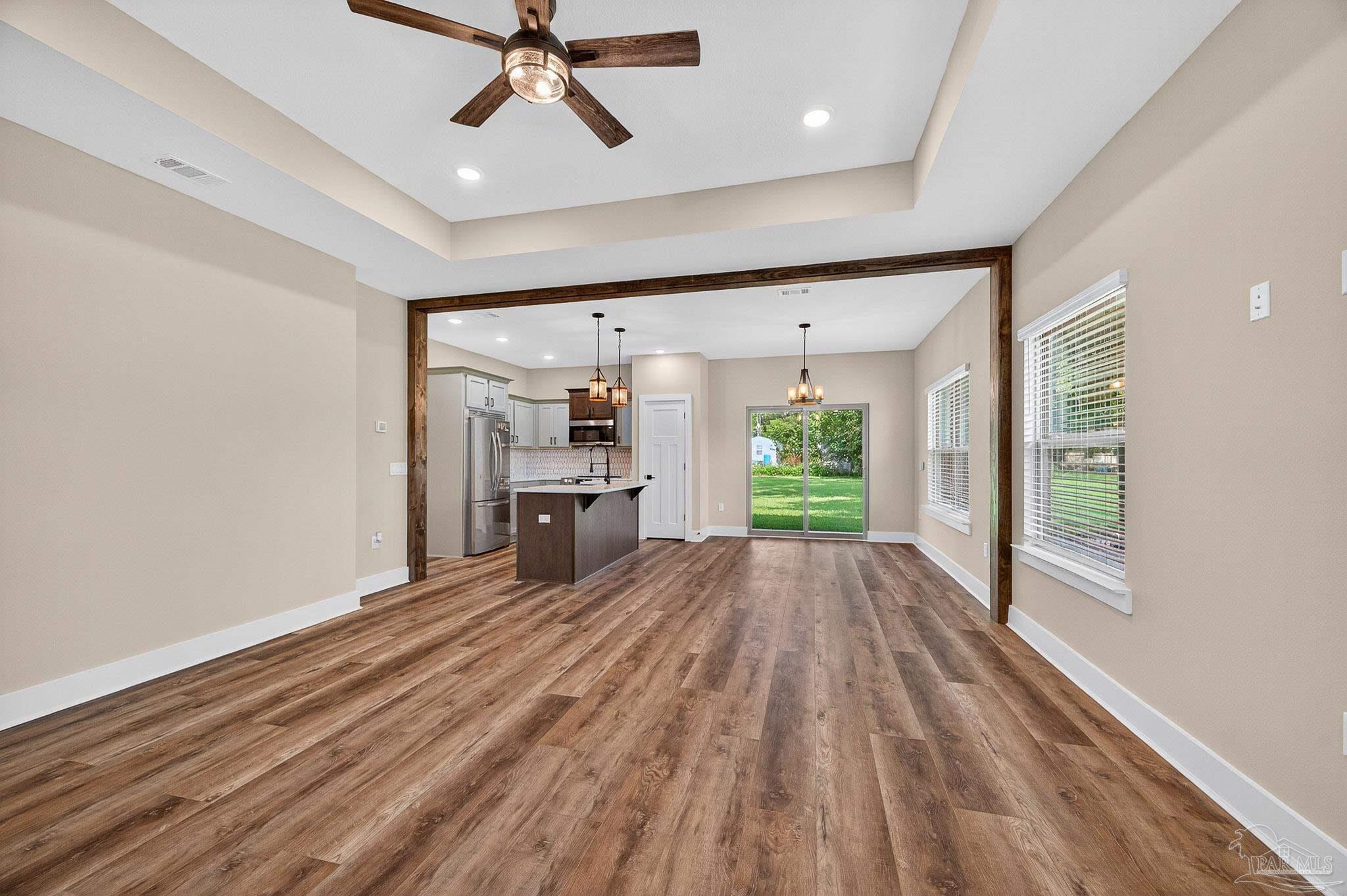 205 Webb Street Cantonment, FL 32533 - Photo 6 of 49 a view of empty room with wooden floor and fan