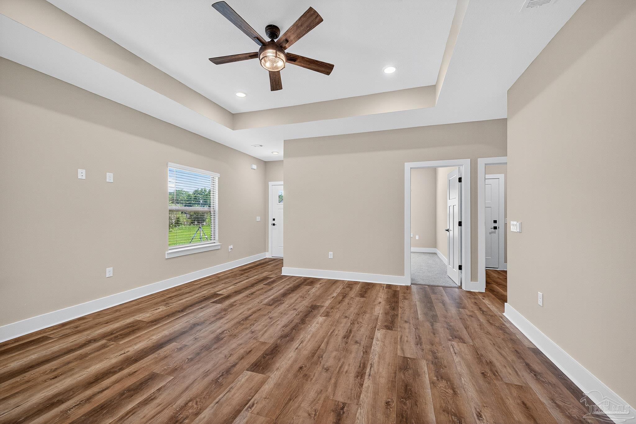 205 Webb Street Cantonment, FL 32533 - Photo 9 of 49 a view of empty room with wooden floor and fan