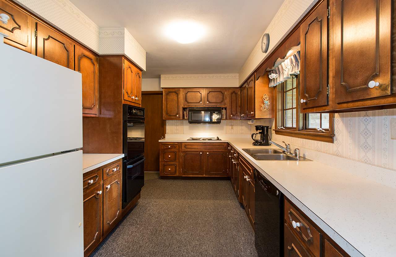3906 Landstrom Road Rockford, IL 61114 - Photo 3 of 12 a kitchen with stainless steel appliances granite countertop a refrigerator a stove and a sink
