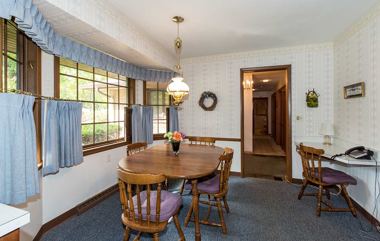 3906 Landstrom Road Rockford, IL 61114 - Photo 5 of 12 a living room with dining table and a large window