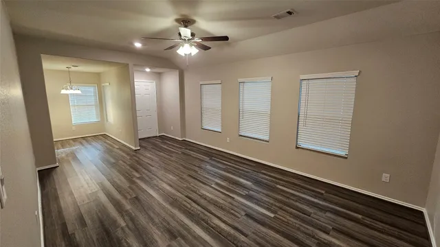 wooden floor in an empty room with a window