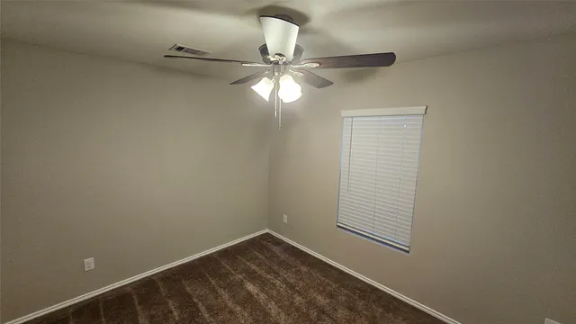 a view of an empty room with a fan