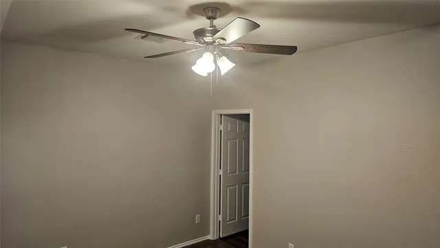 a view of room with a ceiling fan and window
