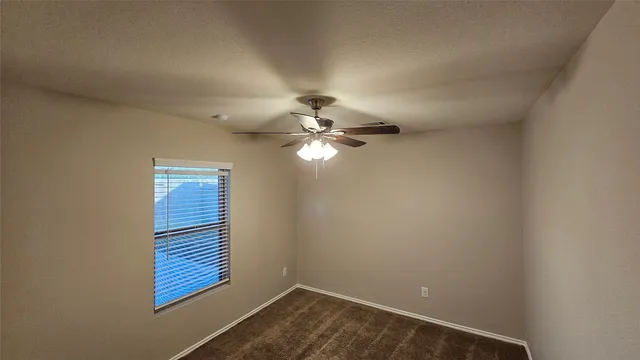 a view of an entryway and a chandelier fan