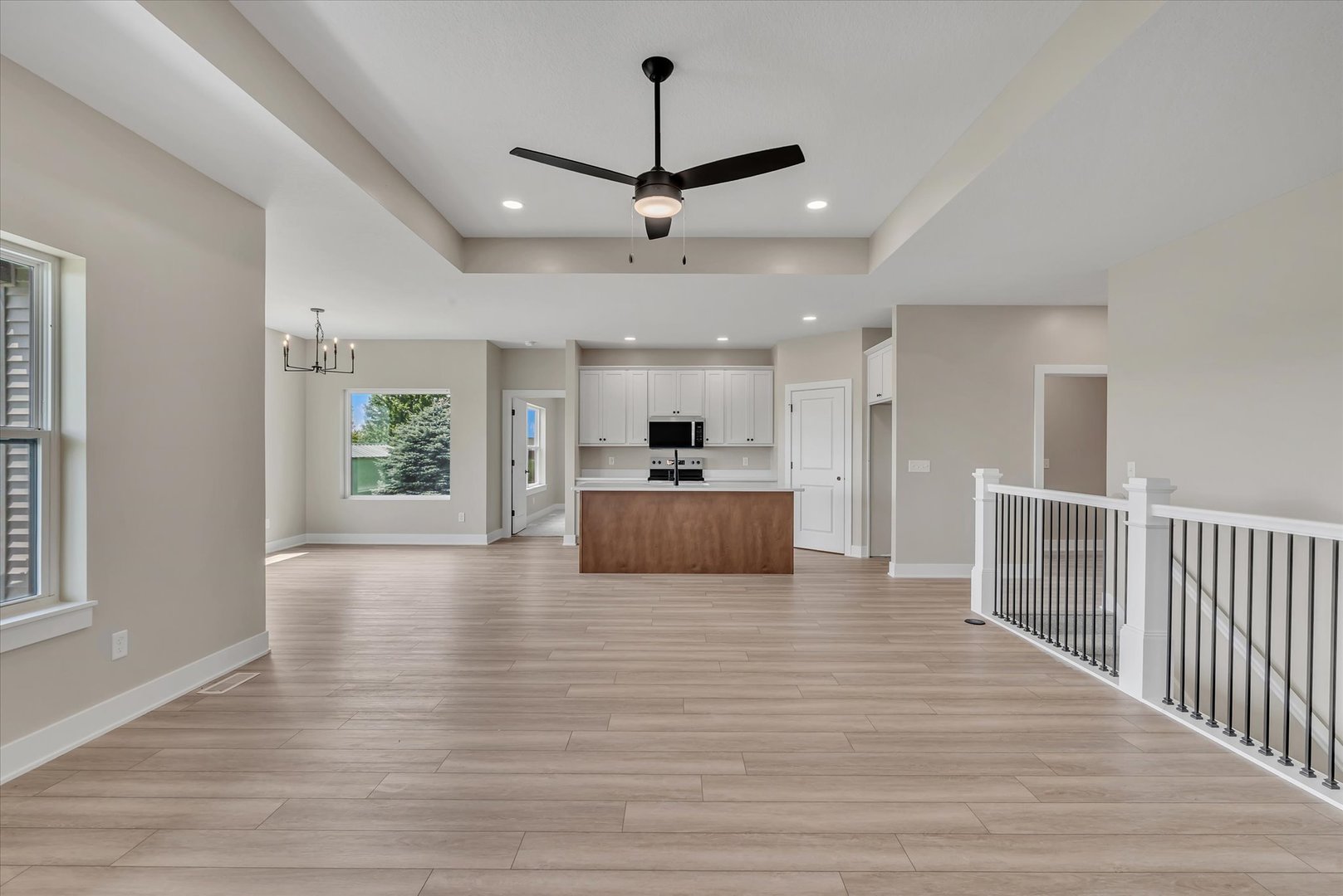 455 Rhonda Road New Liberty, IA 52765 - Photo 18 of 54 a view of a kitchen with a sink wooden cabinet and a ceiling fan