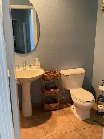 a bathroom with a sink toilet and mirror