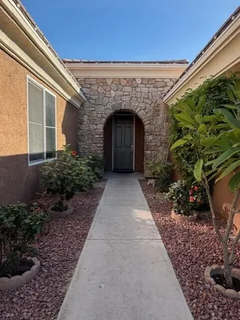 a front view of a house with a garden